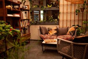 a living room filled with furniture and plants at The Circus Hotel in Berlin