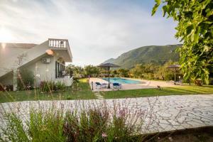 a villa with a swimming pool and a house at Villa Adonis in Halikounas