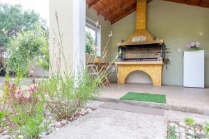 a patio with an outdoor oven in a house at Villa Adonis in Halikounas