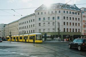 a yellow train on a street in front of a building at The Circus Hotel in Berlin