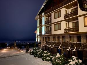 a hotel in the snow at night at Luxury private studio in Paradiso Verde in Bansko