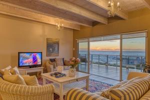 a living room with a view of the ocean at Stanford's Cove Villas in Gansbaai