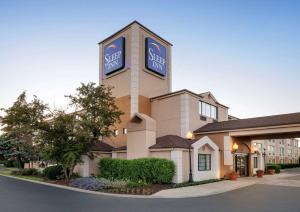 a hotel building with a sign for a safe suite at Sleep Inn Midway Airport Bedford Park in Chicago