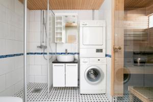 a bathroom with a washing machine and a washer at 2ndhomes Apartment in Kamppi Center with Sauna and Balcony in Helsinki