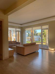 a large living room with couches and windows at Green Gold Park in Selishche