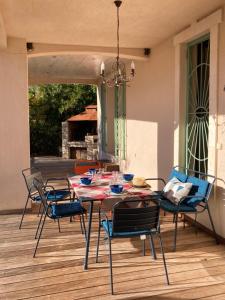 a dining room table and chairs on a patio at Villa les écureuils in Fréjus