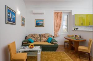 a living room with a couch and a table at Anima Mea Apartment in Dubrovnik