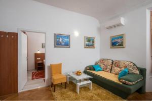 a living room with a couch and a table at Anima Mea Apartment in Dubrovnik