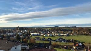 a small town with houses and a green field at Panorama Apartmenthaus in Vöcklamarkt