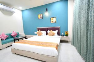 a bedroom with a bed and a blue wall at The Sky Imperial- Hotel Gopal Darshan in Nāthdwāra