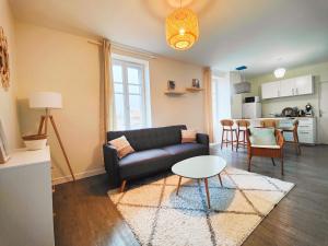 a living room with a couch and a table at T2 neuf Le SCANDINAVE in Riom