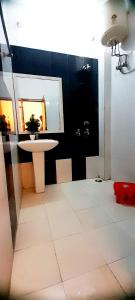 a bathroom with a sink and a table and a mirror at Bhambri Expo House in Greater Noida