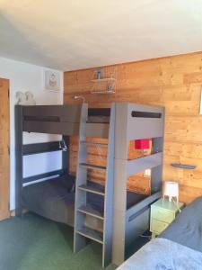 a bedroom with two bunk beds and a desk at Duplex skis aux pieds Belle Plagne in Belle Plagne +12 photos