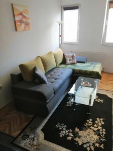 a living room with a couch and a table at Dunja - Sajam in Novi Sad