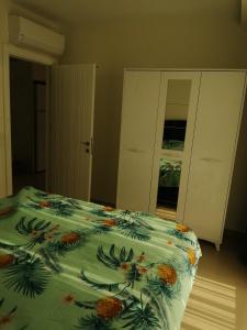 a bedroom with a bed with a green comforter at Siberland olive garden 1+1 residence spa - pool in Alanya