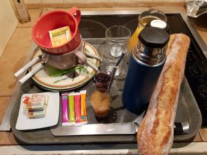 a kitchen counter with a sink with a mixer and food at Chambre d’hôtes de Vauguenige in Saint-Pardoux