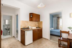 a kitchen with a sink and a counter top at Apollon Apartments in Kassiopi