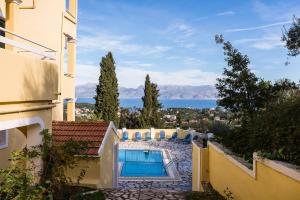 a view of a house with a swimming pool at Apollon Apartments in Kassiopi
