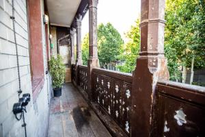 an empty porch of a house with a fence at Majestic Historic Apartment in Tbilisi City
