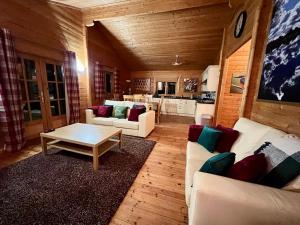 a living room with white couches and a table at Tufty Lodge, Lake Pochard lodge 9 in South Cerney +21 photos