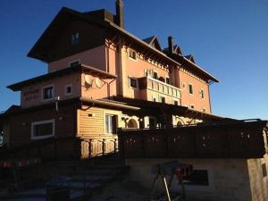 a large wooden house on top of a building at Principessa Giovanna Boutique Chalet in Roccaraso