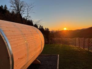 um barco de madeira sentado num quintal com o pôr-do-sol em Ferienhaus Wendelinus mit Pool & Sauna em Hausach