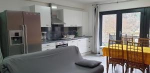 a kitchen with a table and a kitchen with a yellow tablecloth at Presqu'île de Chooz in Chooz