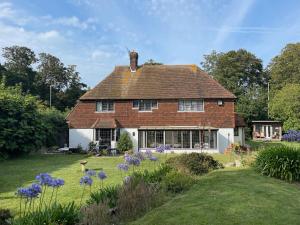 a large house with a yard with purple flowers at Detached Private House in Margate