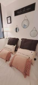a bedroom with two pillows on a white bed at Cosy Corner in LʼIsle-sur-la-Sorgue