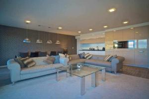 a living room with two couches and a glass table at The best in San Sebastian in San Sebastián