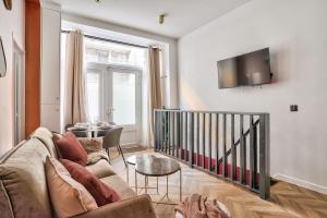 パリにあるNEW Eiffel Tour ! Splendid Apartments in the Heart of Parisのソファとテーブルのあるリビングルーム