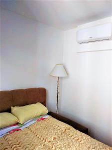 a bedroom with a bed and a lamp in it at BarraVilha Resort Vista Mar e Pé na Areia in Barra Velha +22 photos