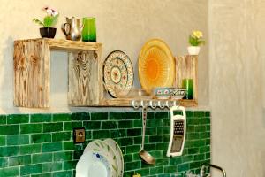 a shelf with plates and a mirror on a kitchen counter at La casa de papel in Essaouira +31 photos