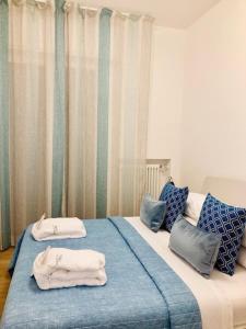 a bedroom with two beds with towels on them at MALU LUXURY APARTMENTS in Rimini