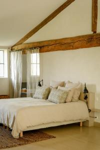 a bedroom with a large white bed with pillows at Mas des Prêcheurs in Tarascon +70 photos