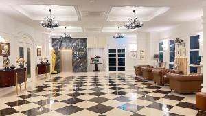 a lobby with a black and white checkered floor at Le Cannes Hotel in Chiang Mai