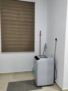 a bathroom with a toilet and a sink in a room at Wipah Guest House in Kampung Lundang, Kota Bharu in Kota Bharu