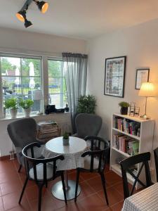 a living room with a table and chairs at Hotell Vellingebacken in Vellinge