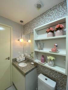 a bathroom with a sink and a toilet at Muro Alto Clube Residence in Ipojuca