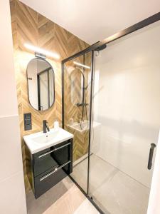 a bathroom with a sink and a shower at Apartament IV piętro in Ustka
