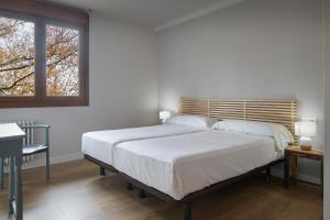 Cama o camas de una habitación en Hostal rural Aritzalko