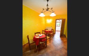 a dining room with a red table and chairs at B&B Il Casale in Castel di Sangro