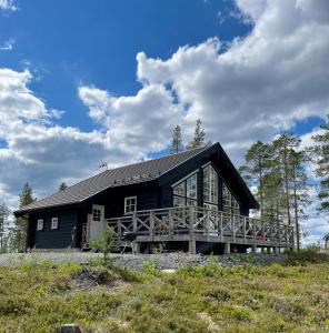 a large black house with a wooden deck at Idre Himmelfjäll, Vintergatan 2 in Idre