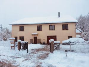 a house covered in snow in front at Les 3Crokignols, maison d’hôte familiale. in Saffloz