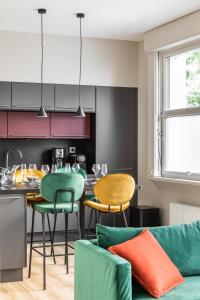 a kitchen and living room with a table and chairs at ARNEM - cosy T3 in Rennes +7 photos