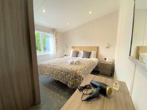 a bedroom with a bed and a phone on the floor at The Yorkshire Burrow Lodge with Hot Tub in York