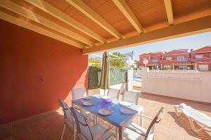 a table and chairs on the patio of a house at Bungalow Java - Plusholidays in Calpe