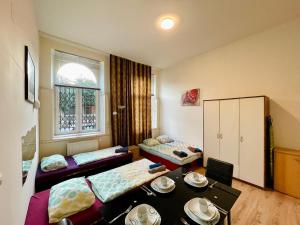 a kitchen filled with furniture and a table at Raisa Apartments Lerchenfelder Gürtel 30 in Vienna