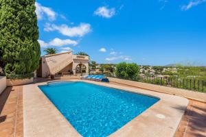 a swimming pool in front of a house at Villa Rodrigo - PlusHolidays in Benissa