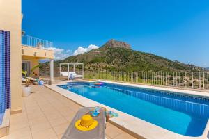 a swimming pool with a mountain in the background at Villa Orion - Plusholidays in Calpe